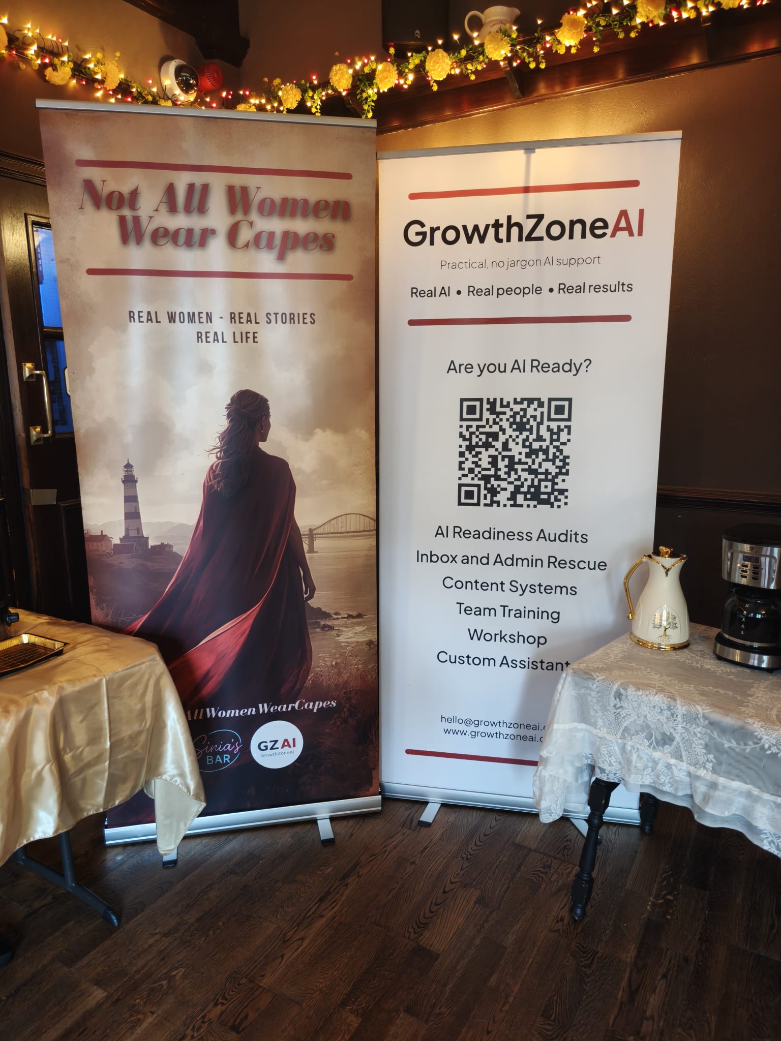 The Not All Women Wear Capes banner alongside the GrowthZone AI banner at the South Shields event